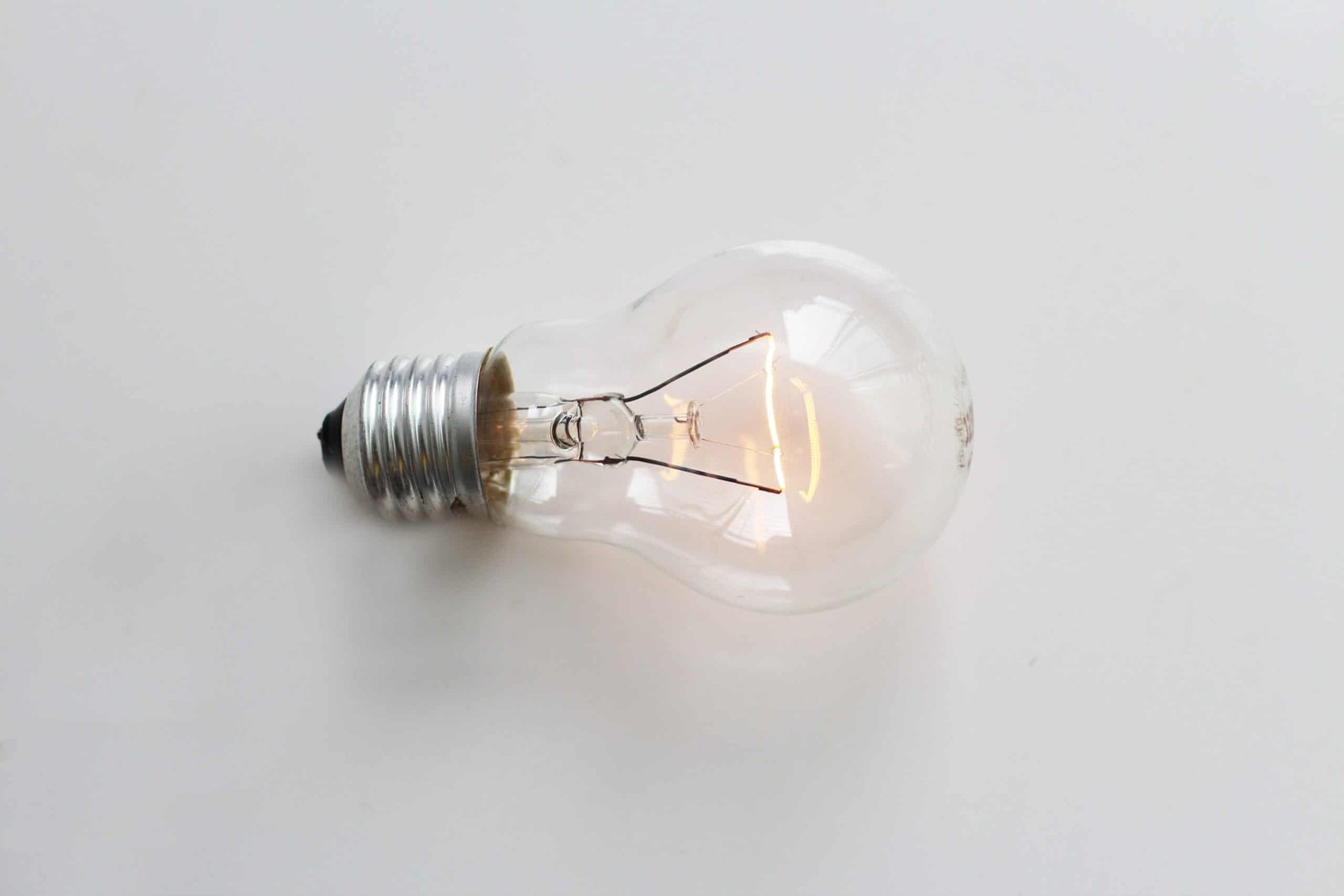 A lightbulb resting on a table.